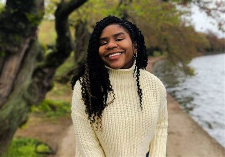 Trinitee Stokes with posing for the photo with a black curly hair
